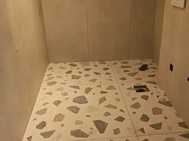 Bathroom mid-renovation with textured flooring installed