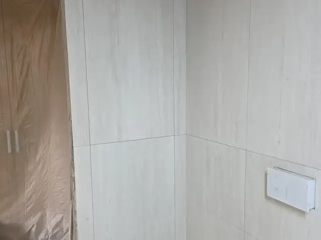 Bathroom corner tiling in progress