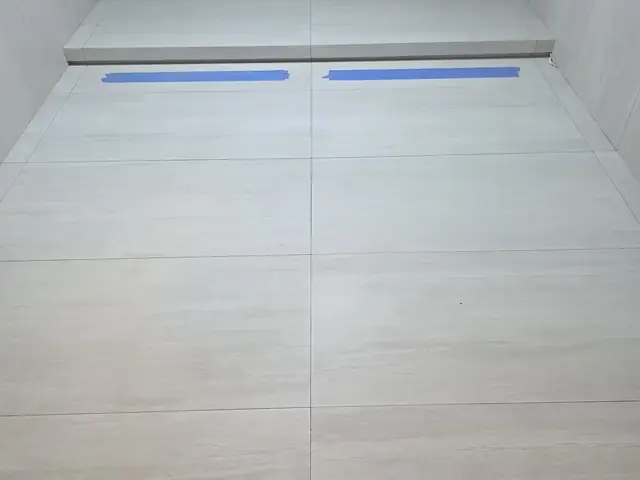 Bathroom floor tiling with shower drain installed