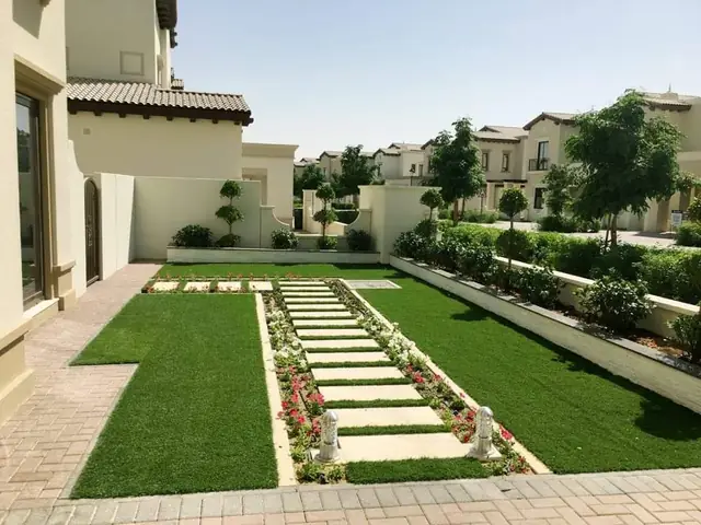Villa garden landscaping with paver pathway and flower beds