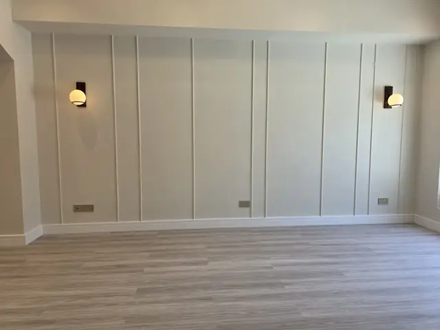 Wall paneling and sconce lighting installation
