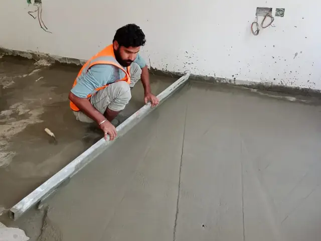 Fixmania team leveling floor screed on site
