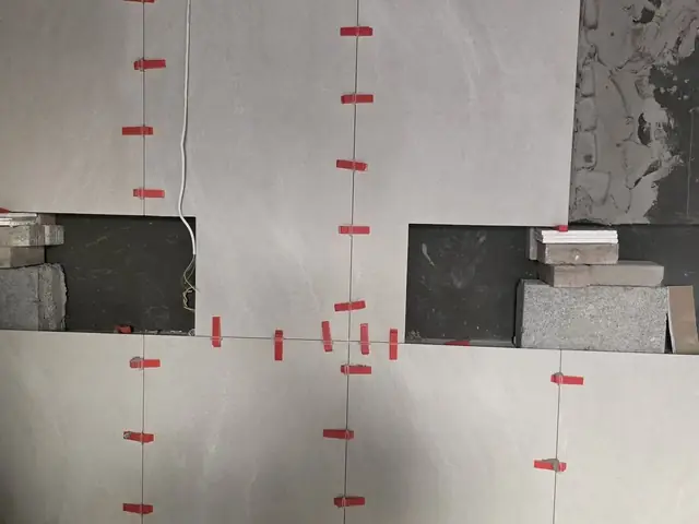 Wall tiling work in progress with leveling clips