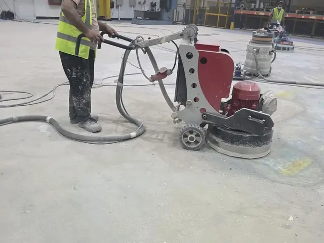 Fixmania technician operating floor grinder