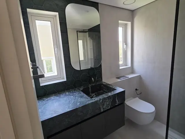 Bathroom renovation with green hexagon tile, Dubai