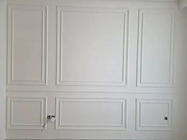 Completed gypsum wall paneling feature wall