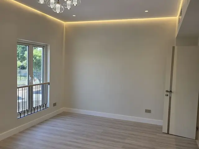 Finished room with new flooring and lighting