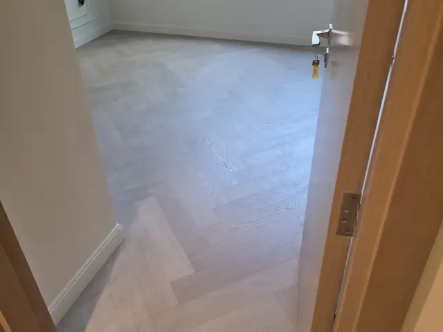 Herringbone parquet flooring installation with garden view