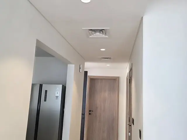 Finished hallway with recessed lighting and AC diffuser