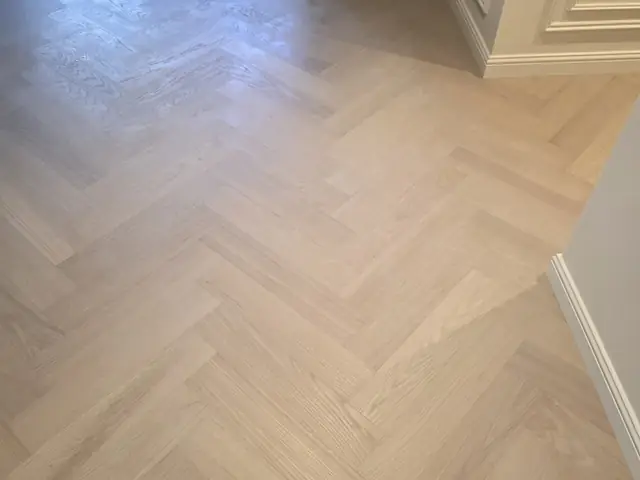 Herringbone parquet flooring installation near kitchen