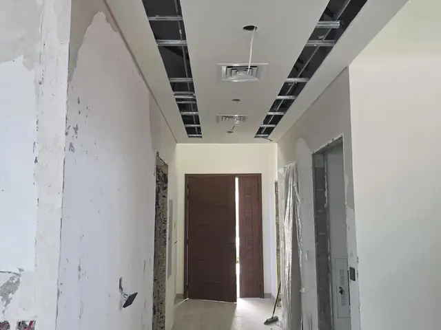 Villa hallway under renovation with gypsum ceiling framing
