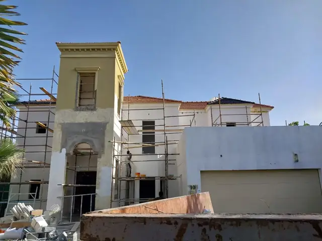 Villa facade renovation with scaffolding and plastering