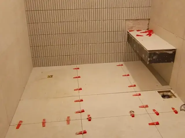 Bathroom mosaic tiling installation in progress