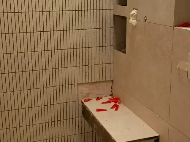 Bathroom tiling with built-in niche shelving in progress