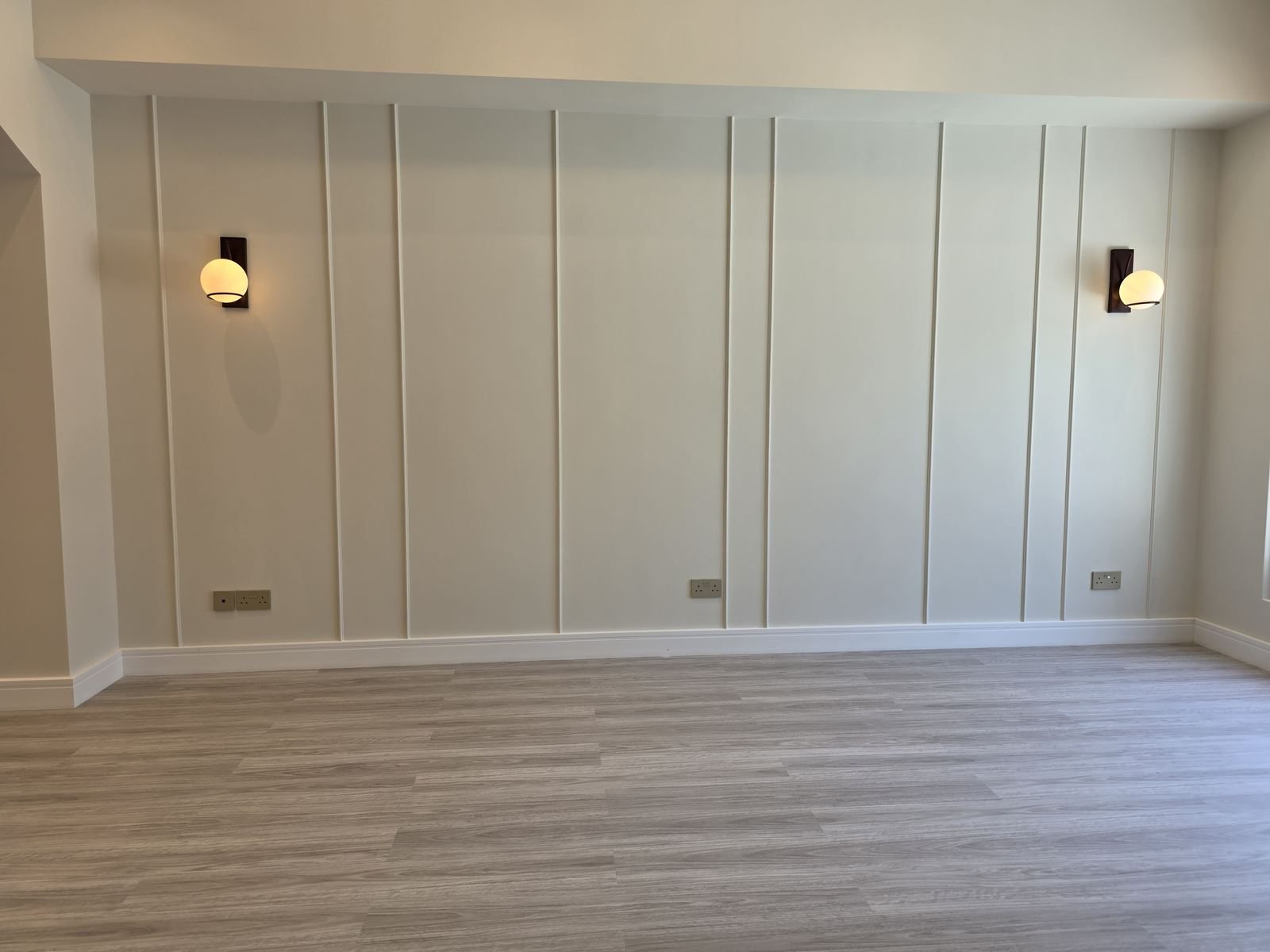 Wall paneling and sconce lighting installation