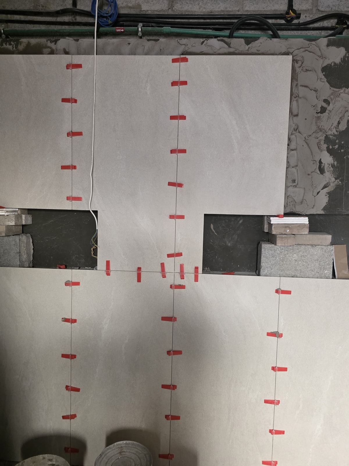 Wall tiling work in progress with leveling clips
