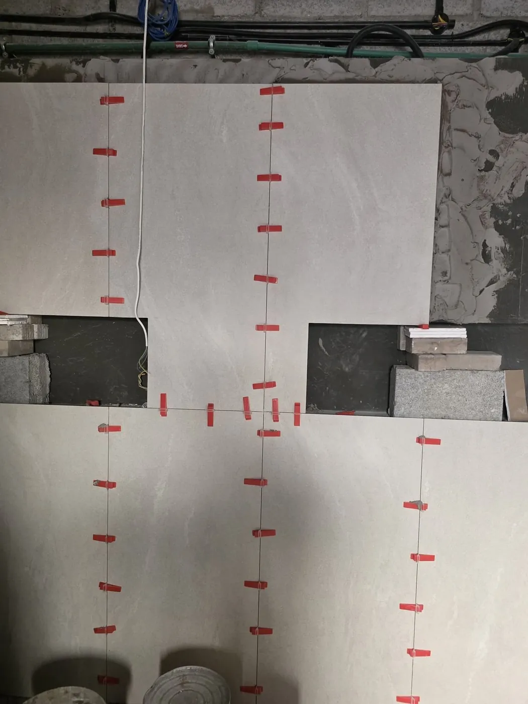 Wall tiling work in progress with leveling clips