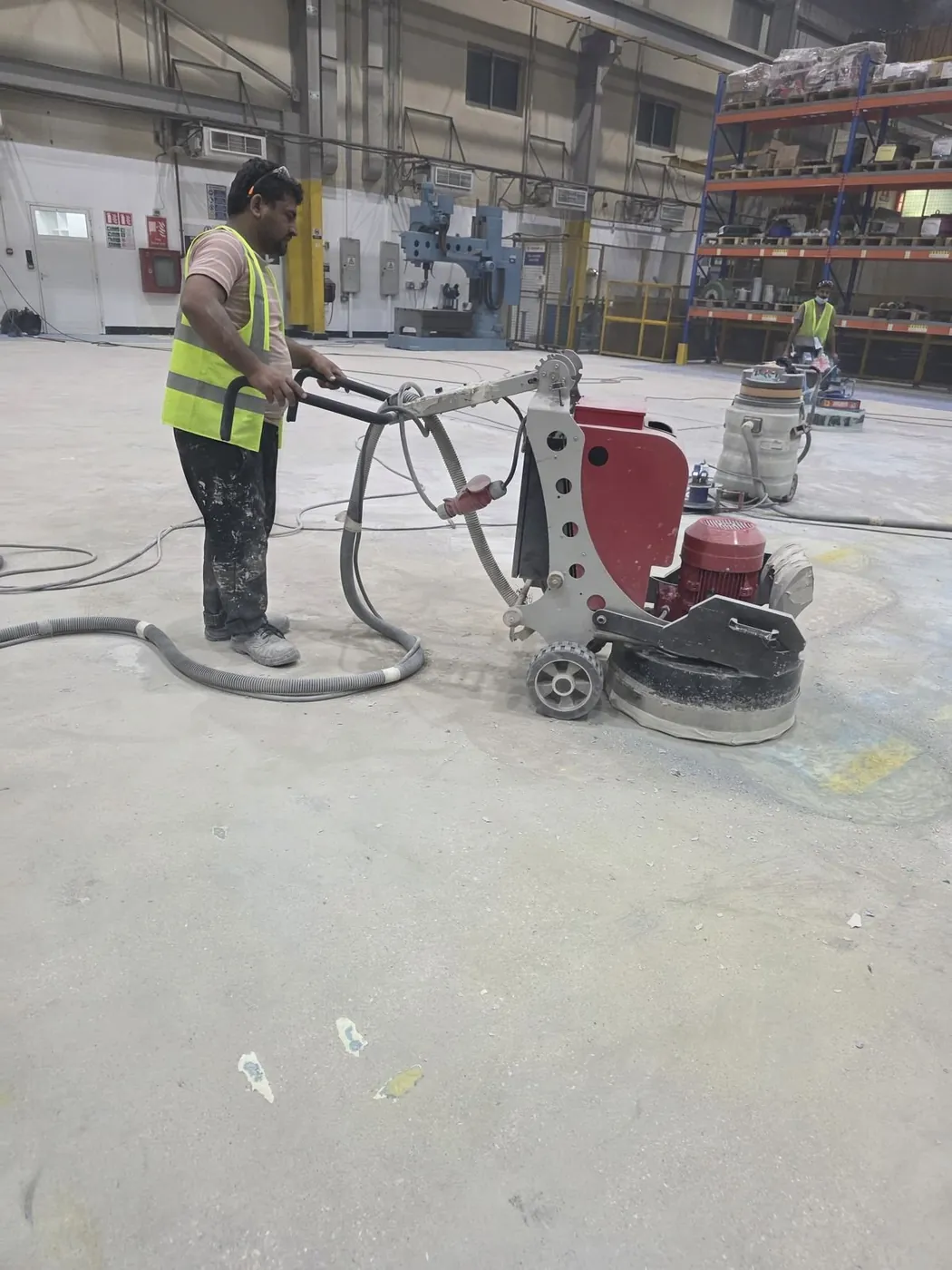 Fixmania technician operating floor grinder