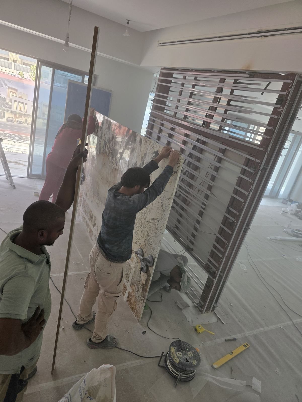 Team fitting large granite slab on site