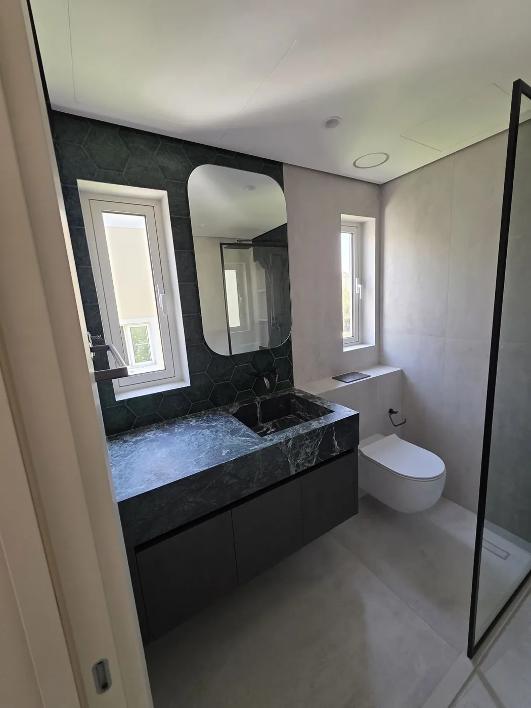 Bathroom renovation with green hexagon tile, Dubai