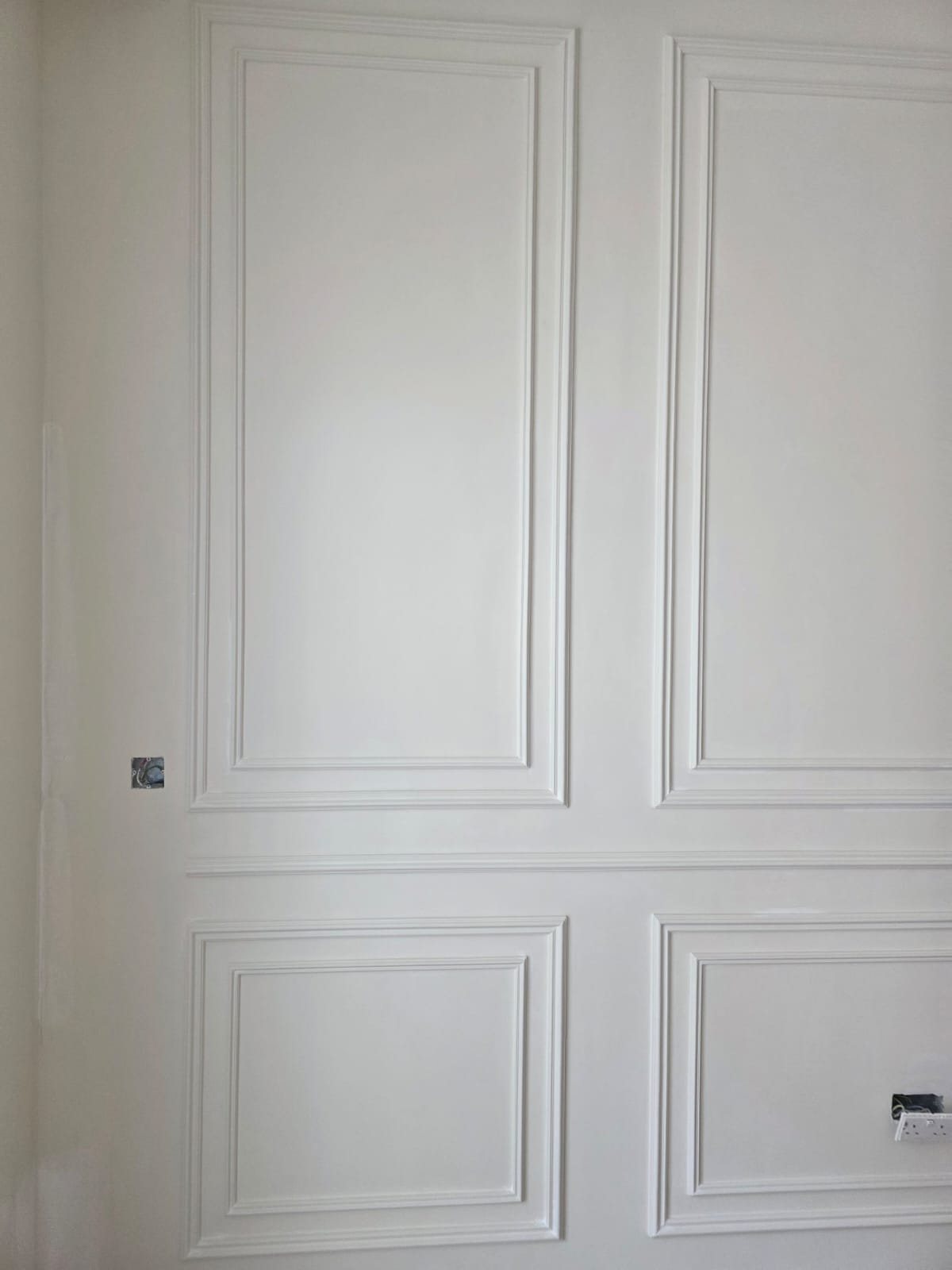 Finished decorative gypsum wall paneling with wainscoting detail