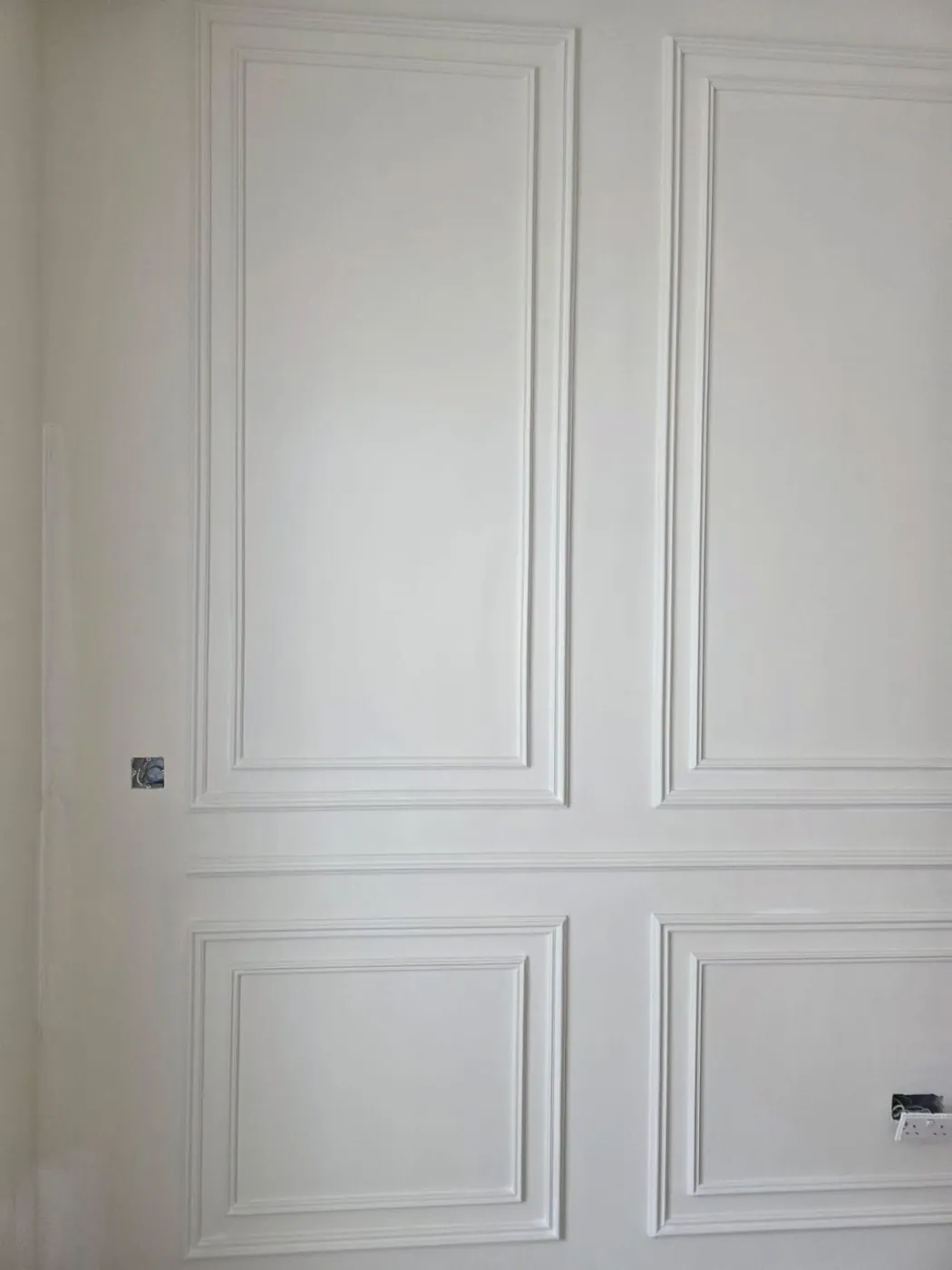 Finished decorative gypsum wall paneling with wainscoting detail