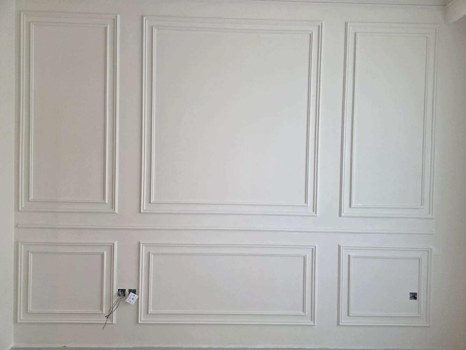 Completed gypsum wall paneling feature wall