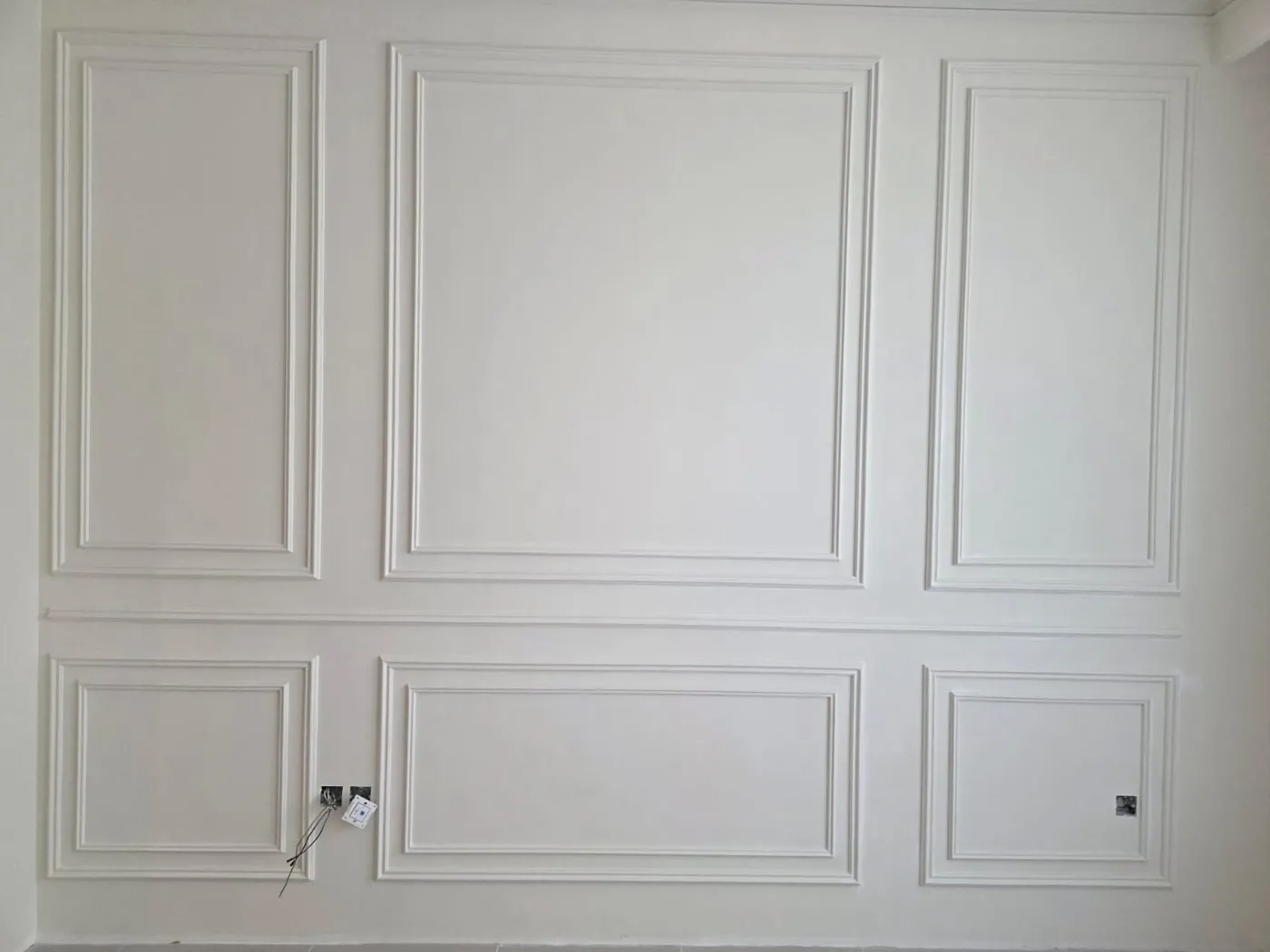 Completed gypsum wall paneling feature wall