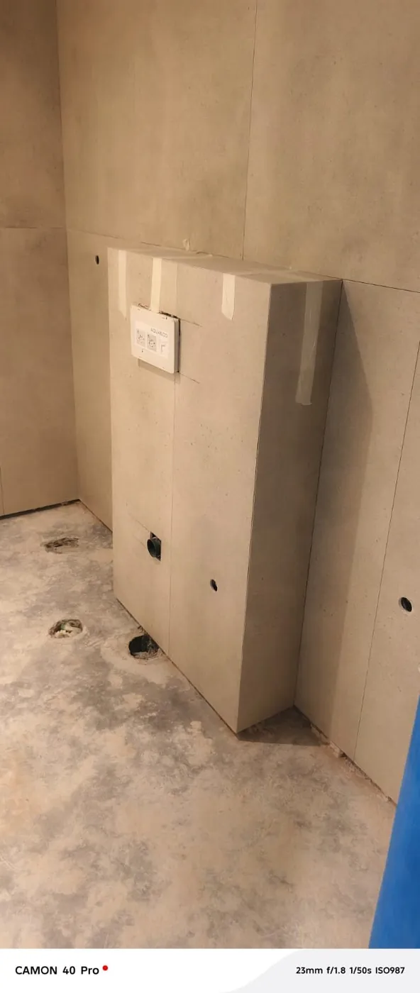 Concealed cistern unit installation before wall tiling