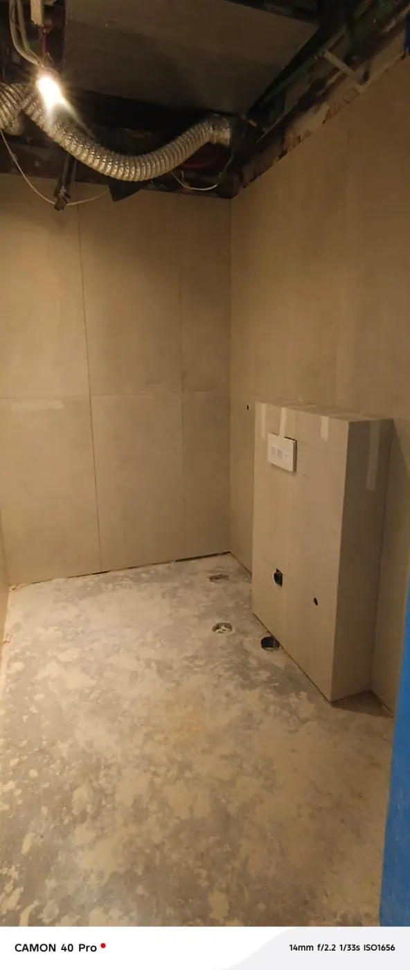 Completed bathroom wall tiling with concealed cistern