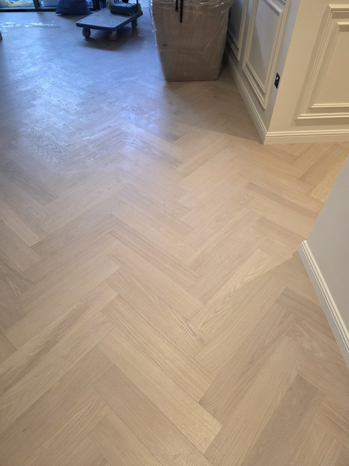 Herringbone parquet flooring installation near kitchen