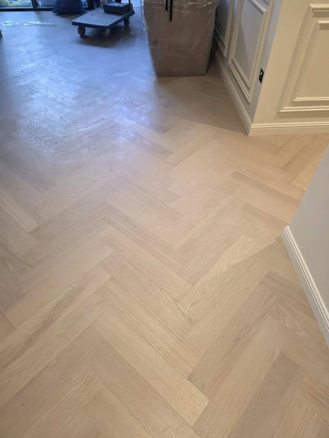 Herringbone parquet flooring installation near kitchen