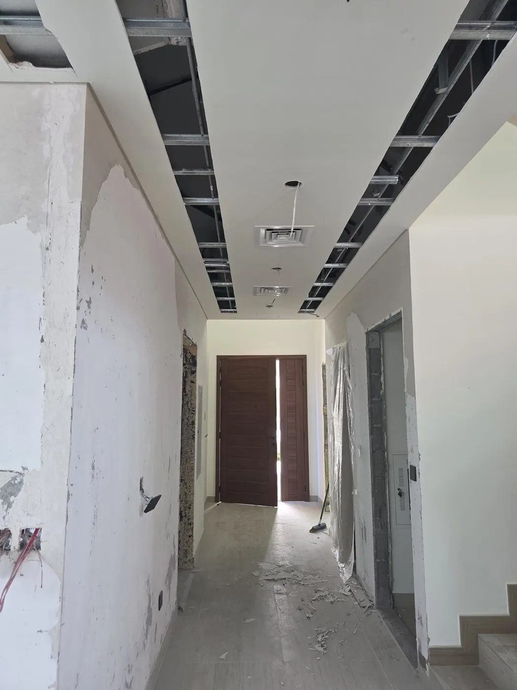 Villa hallway under renovation with gypsum ceiling framing