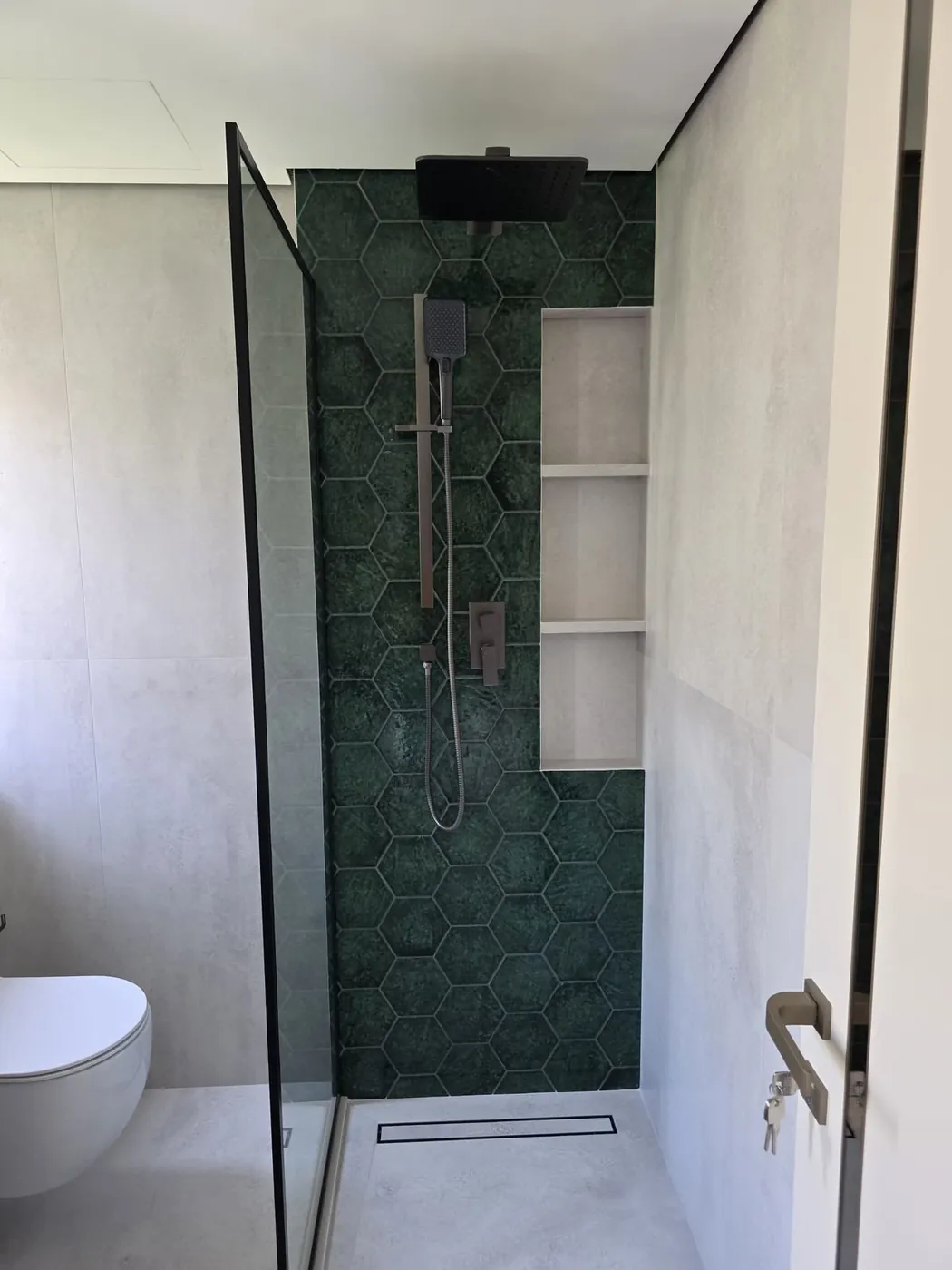 Walk-in shower with hexagon tile and rain shower head