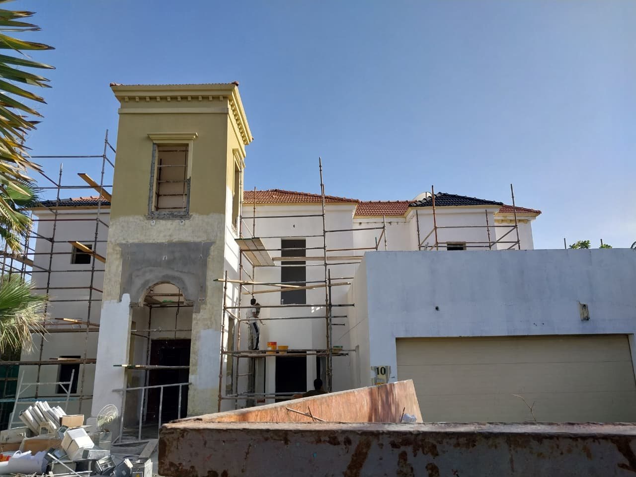 Villa facade renovation with scaffolding and plastering