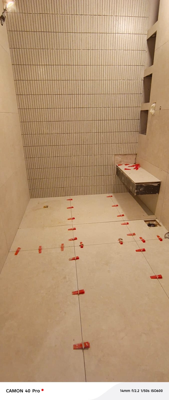 Bathroom mosaic tiling installation in progress
