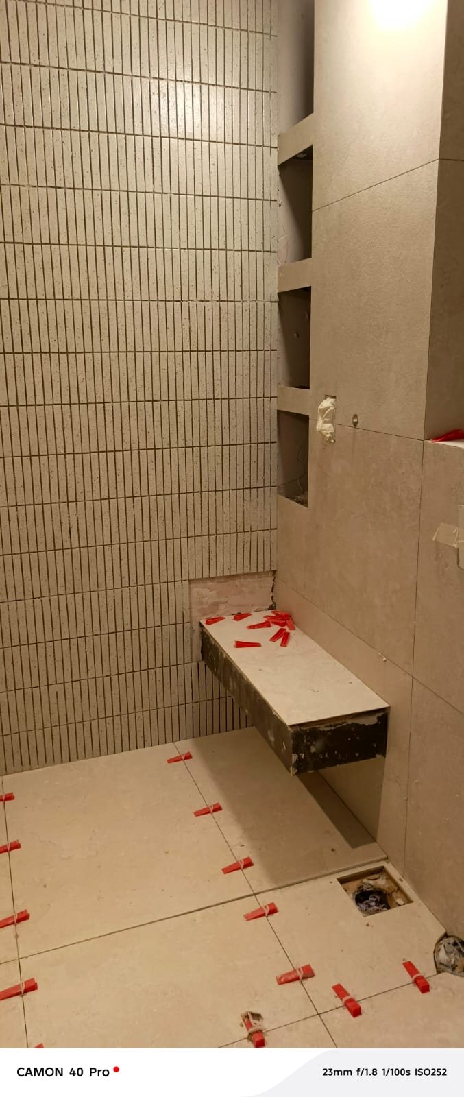 Bathroom tiling with built-in niche shelving in progress