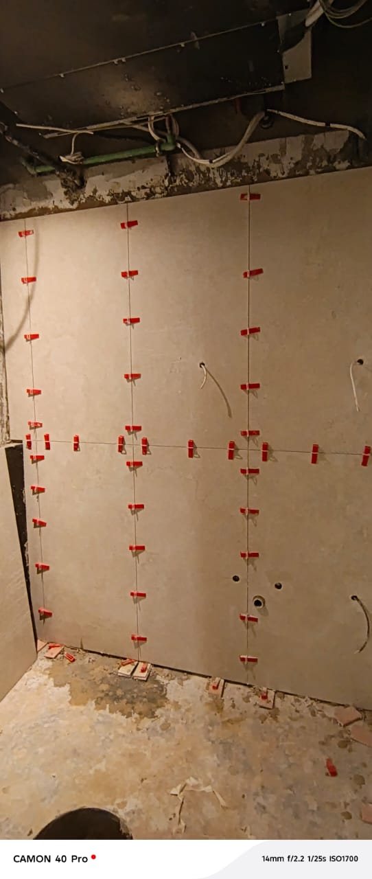 Bathroom wall tiling installation in progress