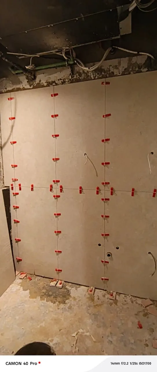 Bathroom wall tiling installation in progress